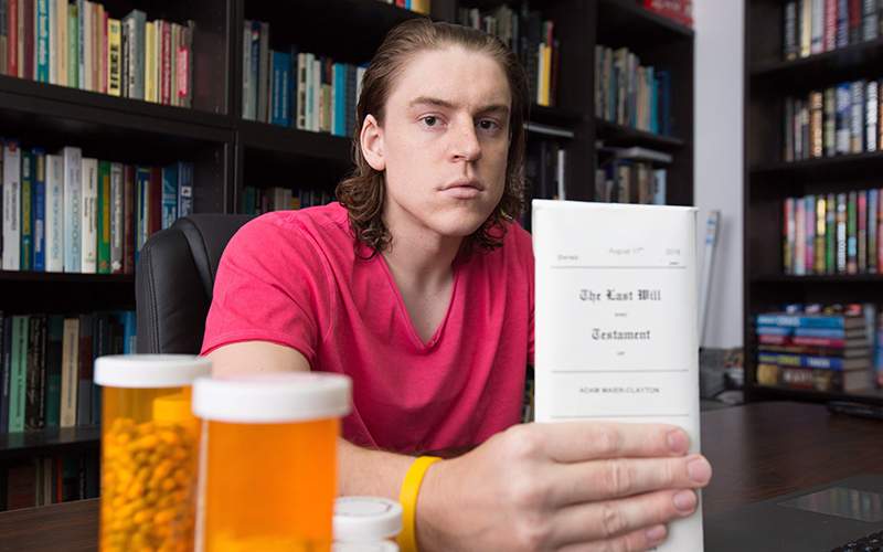 Adam Maier-Clayton, who is fighting for access to medically-assisted dying, holds a copy of his will in Windsor, Ont., on Friday, Sept. 4, 2016.