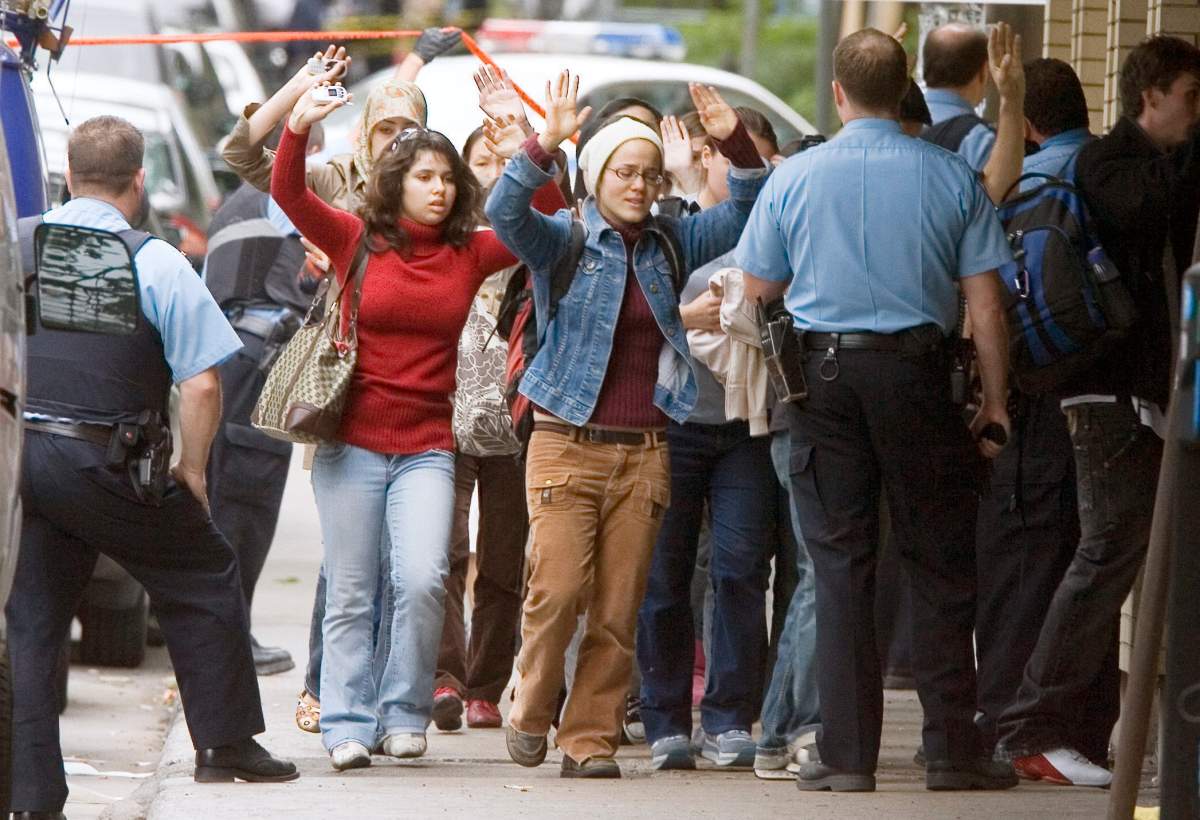 Students evacuate the school during a shooting incident at Dawson College in Montreal, Wednesday, Sept. 13, 2006.