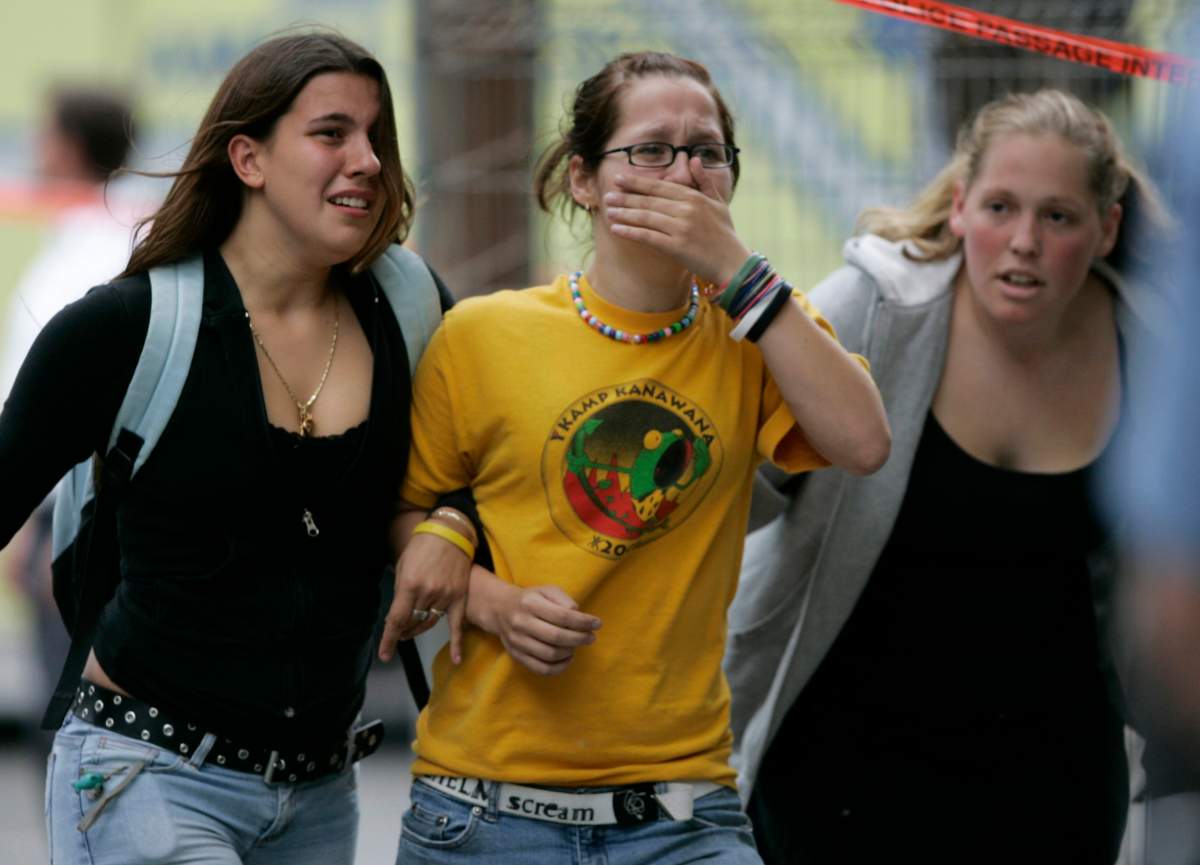 Evacuated students comfort each other during a shooting incident at Dawson College in Montreal, Wednesday, Sept. 13, 2006.