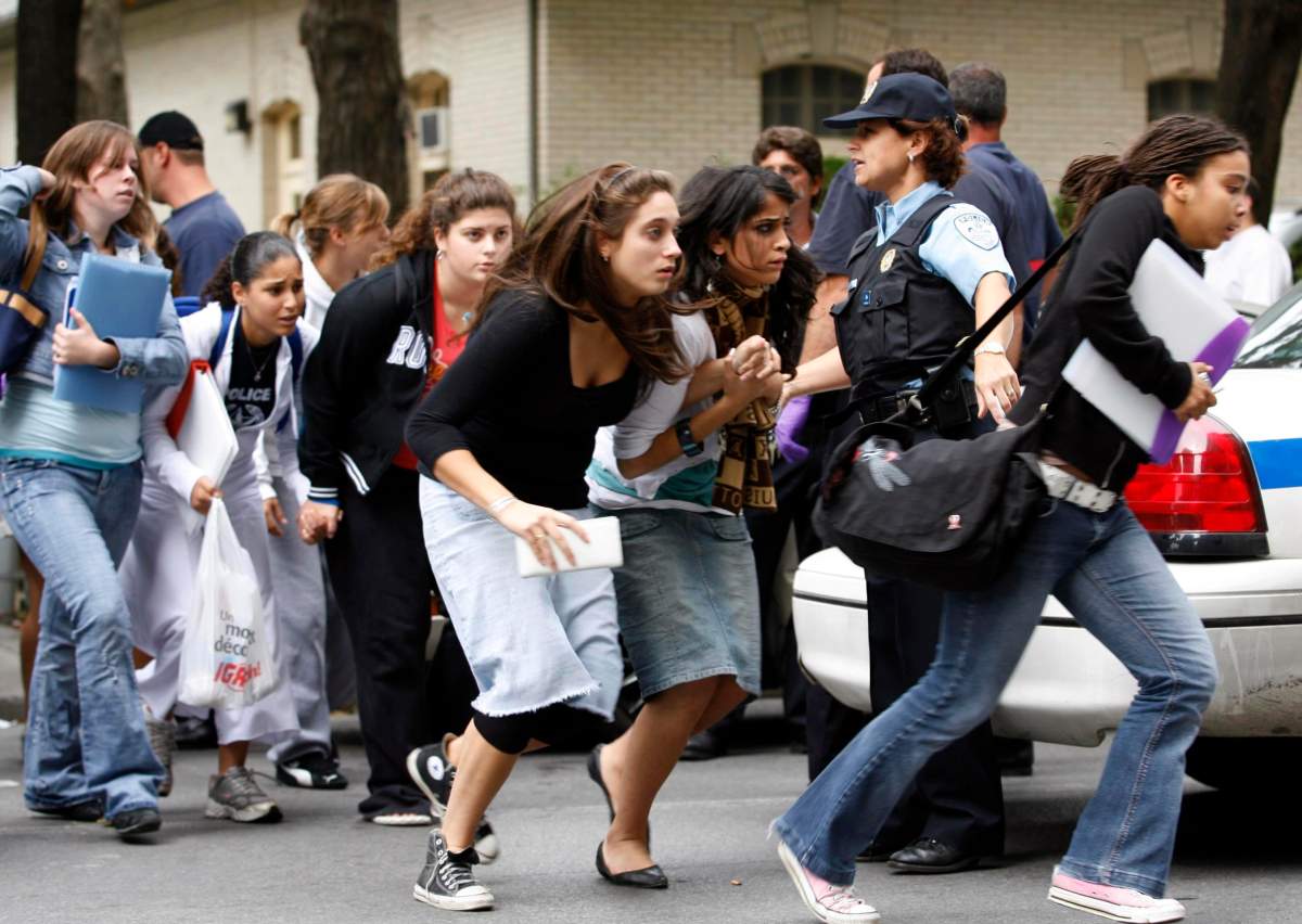 Students run from Dawson College after reports of a gunman in the building in Montreal, Wednesday, Sept.13, 2006.