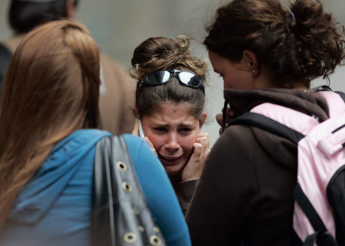 A student breaks down as she talks on a cellphone during a shooting incident at Dawson College in Montreal, Wednesday, Sept. 13, 2006.