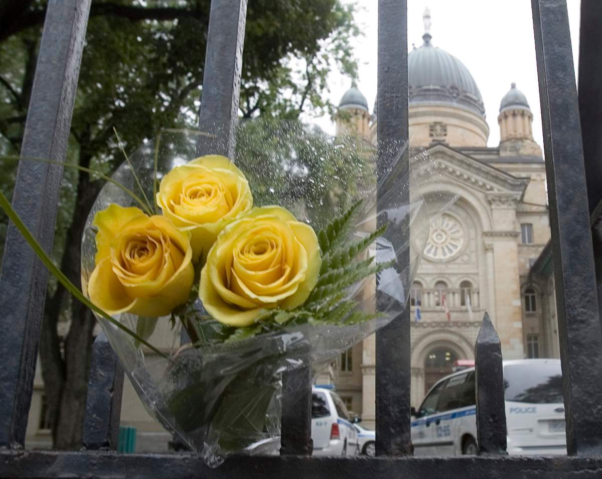 Three yellow roses sit on a fence outside Dawson College in Montreal Thursday, Sept. 14, 2006.