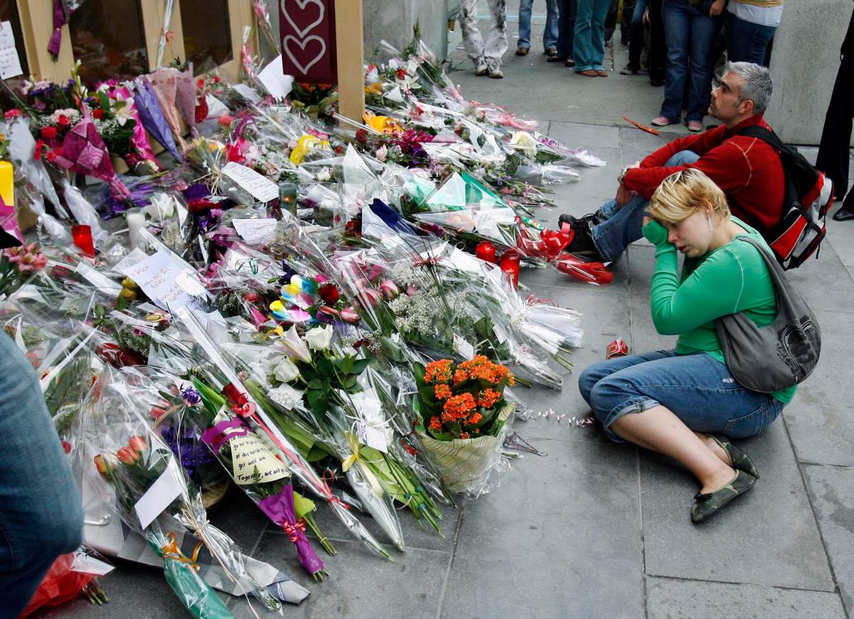 A student is overcome with emotion at a makeshift memorial in front of Dawson College in Montreal Friday, Sept. 15, 2006.