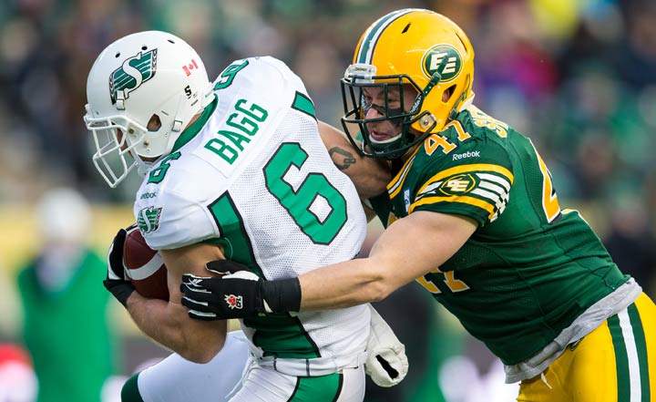 JC Sherritt #47 of the Edmonton Eskimos makes a tackle on Rob Bagg #6 of the Saskatchewan Roughriders in the CFL Western Semi-Final game between the Saskatchewan Roughriders and Edmonton Eskimos at Commonwealth Stadium on November 16, 2014 in Edmonton.