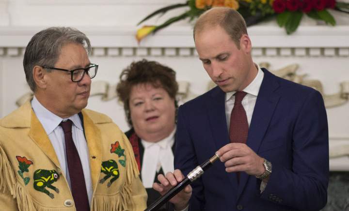 Grand Chief Stewart Philip looks on as the Duke of Cambridge places a Ring of Reconciliation upon the Black Rod during a small ceremony in Victoria, B.C., Monday, Sept 26, 2016.