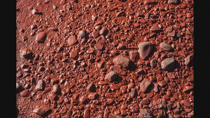 Red rocks and pebbles litter an area where a Russian river turned red on Sept. 7, 2016.