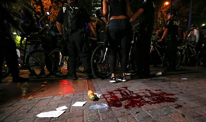 Blood covers the pavement where a person was shot in uptown Charlotte, NC during a protest of the police shooting of Keith Scott, September 21, 2016.