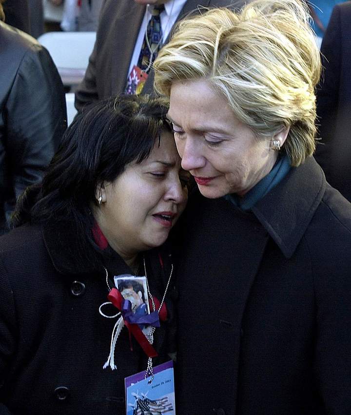 US Senator Hillary Rodham Clinton (R) consoles Maren Sarkar (L) 28 October, 2001, after the World Trade Center Family Memorial Service in New York. (STAN HONDA/AFP/Getty Images)