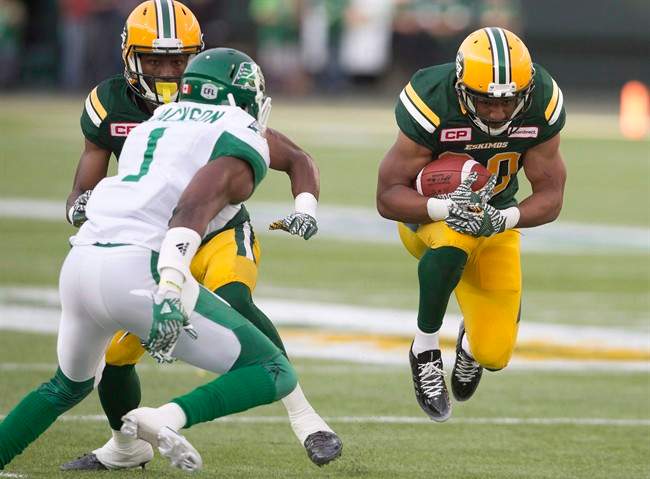 Edmonton Eskimos' John White (30) runs against the Saskatchewan Roughriders' Buddy Jackson (1) defends during first half action in Edmonton, Alta., on Friday July 8, 2016. The Saskatchewan Roughriders' defence will try to slow down Edmonton's running game on Sunday when the Eskimos visit for the final regular season game between the two West Division teams.