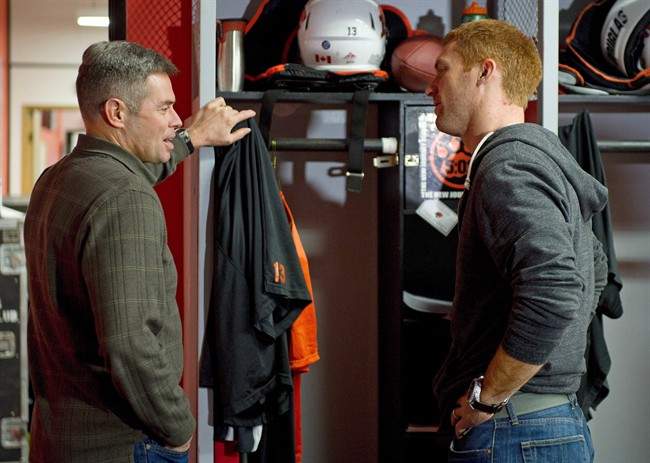 B.C. Lions quarterback Travis Lulay (right) and Jacques Chapdelaine offensive coordinator and quarterbacks coach talk at the team’s practice facility in Surrey, B.C., November 20, 2012.