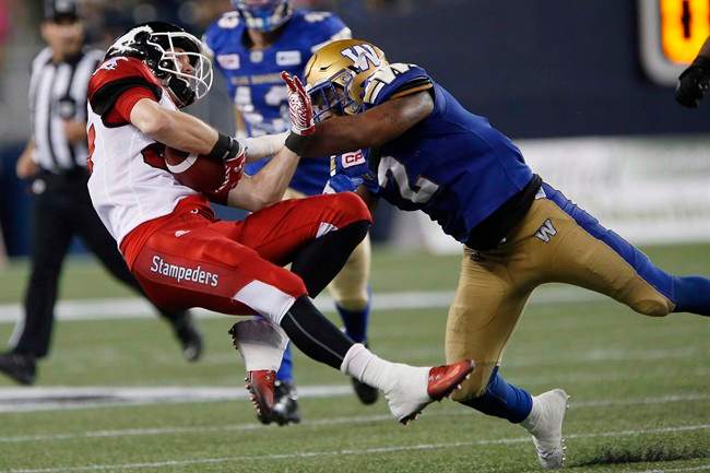 Former Winnipeg Blue Bombers linebacker Khalil Bass tackles Calgary Stampeders' Simon Charbonneau-Campeau during the second half of a CFL game in Winnipeg on July 21, 2016. 