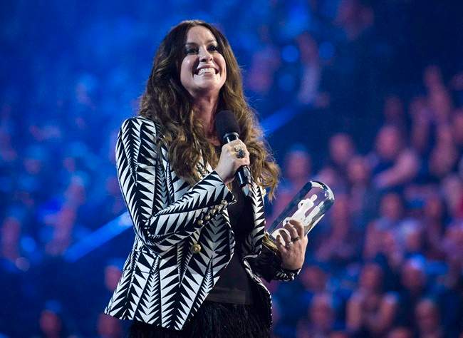 Artist Alanis Morissette receives her achievement from the Canadian Music Hall of Fame during the 2015 Juno Awards in Hamilton, Ont., on Sunday, March 15, 2015.