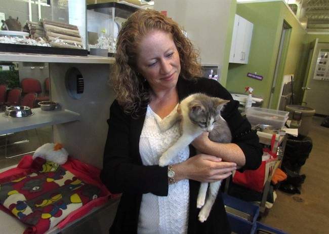 Sage Pullen McIntosh from the Calgary Humane Society poses with one of the adoptees at the shelter on Tuesday Sept. 13, 2016. 