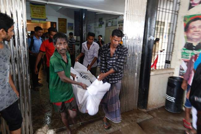 A body of a fire victim is carried into a makeshift morgue at a hospital after a fire broke out at a packaging factory in Tongi industy area outside Dhaka, Bangladesh, Saturday, Sept. 10, 2016. A boiler exploded and triggered a fire at a packaging factory near Bangladesh\’s capital.