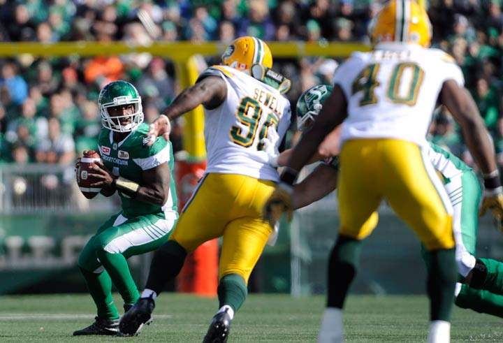 Saskatchewan Roughriders quarterback DarianDurant, left, works under pressure during first half CFL action against the Edmonton Eskimos, in Regina on Sunday, September 18, 2016.