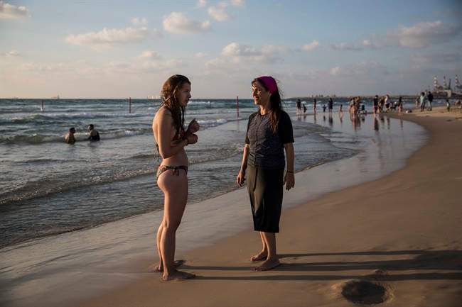 In this photo made on Thursday, Sep. 1, 2016, an Israeli Jewish woman wears modest swimsuite on the beach near the port city of Ashdod, Israel. France's burkini controversy is boosting the bottom line for Israeli makers of modest swimwear. Israel, home to large populations of conservative Jewish and Muslim women, has cultivated a local industry of modest swimsuits, and the full-body outfits that have caused uproar in France have been a common sight on Israeli beaches for several years.