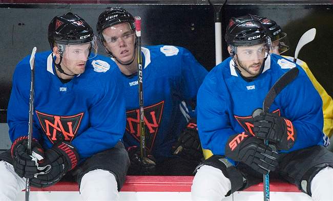 Team North America players, from left, Sean Couturier, Connor McDavid and Vincent Trocheck look on from the bench during training camp in Montreal, Monday, September 5, 2016, ahead of the 2016 World Cup of Hockey competition. 