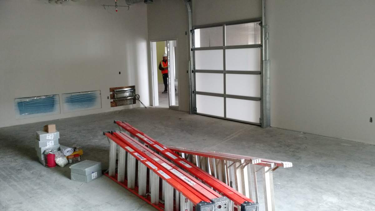 A classroom in Harbour Landing School with a garage door that opens into a multi-purpose area.