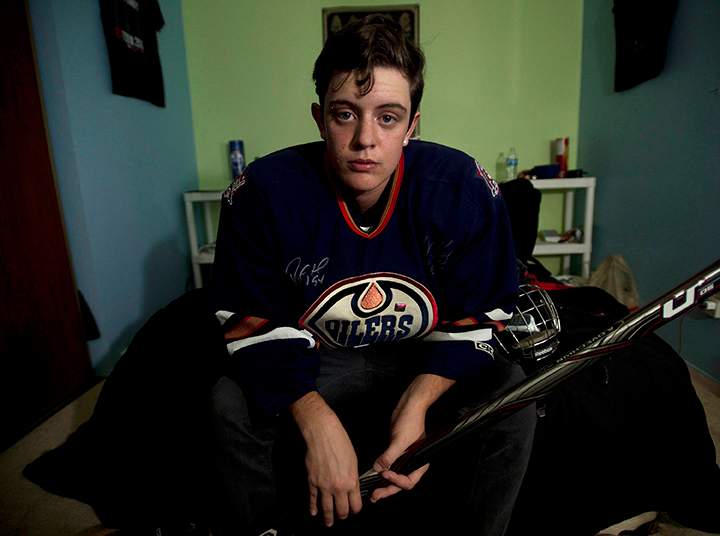 Jesse Thompson, 17, poses for a photograph in his room in Oshawa, Ont., on Monday, September, 15 2014. Thompson is a transgender hockey player who fought for his rights against Hockey Canada. 