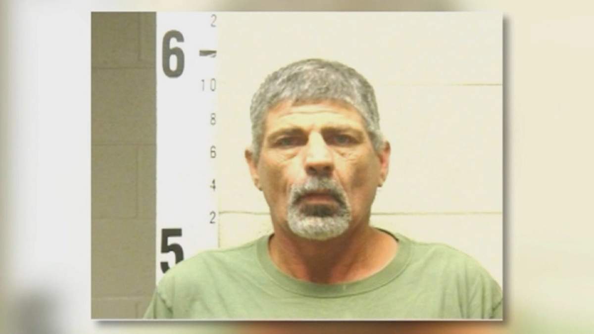 John Higdon, 48, was arrested and charged with reckless endangerment just hours before having his home destroyed by a piece of heavy machinery.