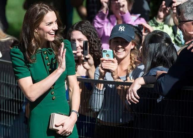 The Duchess of Cambridge waves to people at the University of British Columbia campus in Kelowna, B.C., Tuesday, Sept 27, 2016. 