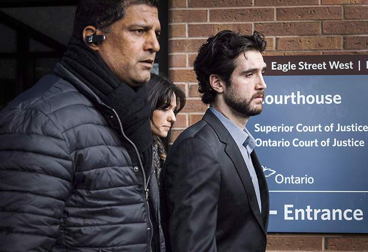 Marco Muzzo, right, leaves the Newmarket courthouse surrounded by family, on February 4, 2016. THE CANADIAN PRESS/Christopher Katsarov
