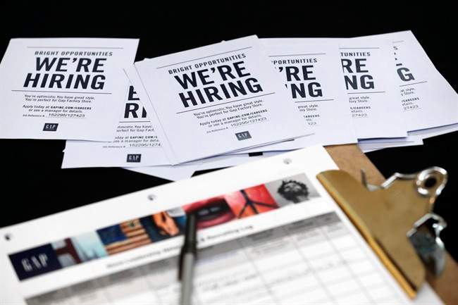 In this Tuesday, Oct. 6, 2015, file photo, job applications and information for the Gap Factory Store sit on a table during a job fair at Dolphin Mall in Miami.
