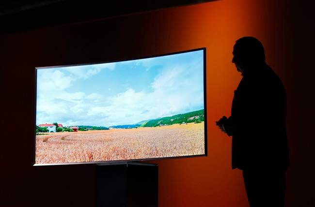 In this Jan. 5, 2015, file photo, Joe Stinziano, executive vice president of Samsung Electronics America, introduces a Samsung SUHD 4K TV at a news conference in Las Vegas.