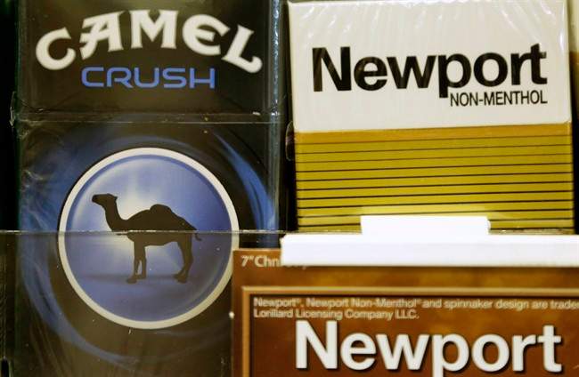 FILE - In this Tuesday, July 15, 2014, file photo, Camel and Newport cigarettes are displayed for sale in Doral, Fla. 