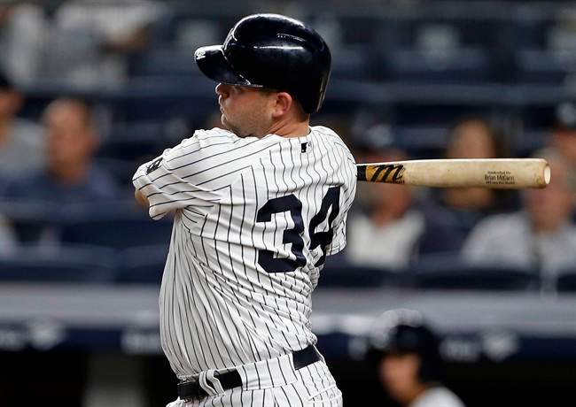 New York Yankees designated hitter Brian McCann follows through on an RBI single during the third inning of a baseball game against the Toronto Blue Jays on Wednesday, Sept. 7, 2016, in New York. 