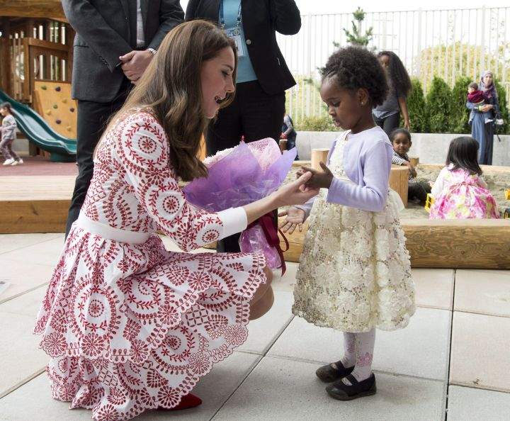 The Duke and Duchess of Cambridge receive flowers from a little girl at the Immigration Services Society in Vancouver, B.C., Sunday, Sept 25, 2016.