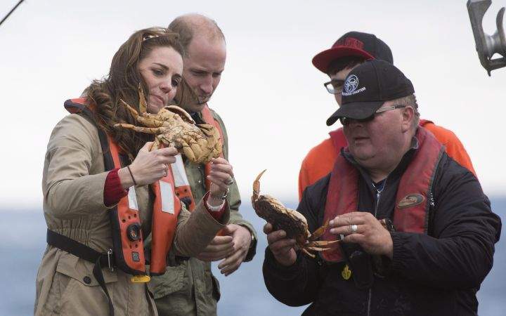 The Duke and Duchess of Cambridge hold crab after pulling a crab trap in Skidegate, B.C. Friday, Sept 30, 2016.