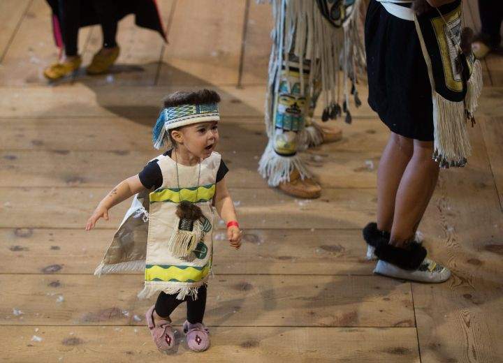 A young girl from the Haida First Nation dances during a welcoming ceremony for the Duke and Duchess of Cambridge at the Haida Heritage Centre and Museum in Haida Gwaii, B.C., on Friday Sept. 30, 2016.