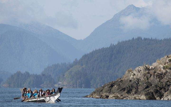 The Duke and Duchess of Cambridge paddle with a group in a traditional Haida canoe in the waters of Haida Gwaii, Friday, Sept. 30, 2016.