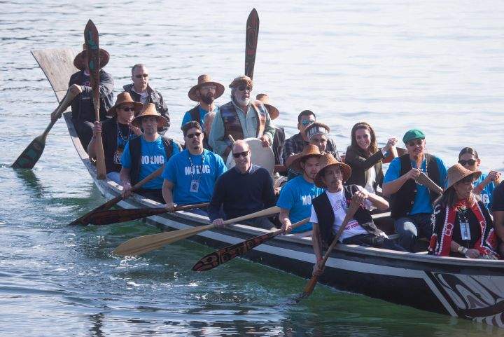 The Duke and Duchess of Cambridge paddle with a group in a traditional Haida canoe in the waters of Haida Gwaii, Friday, Sept. 30, 2016. Paddlers were wearing “No LNG” shirts to protest the recently approved project.