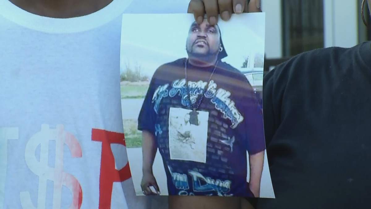 A photo of Terence Crutcher is held up during a press conference.