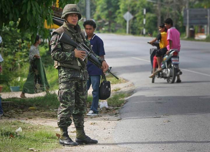 A Thai soldier mans a checkpoint as others look on near Pattani, in southern Thailand April 13, 2007. The human rights group Amnesty International on Tuesday, Jan. 13, 2009 accused Thai military of engaging in systematic torture including beatings and electric shock that killed at least four people in a campaign to defeat Islamic insurgents in the restive south.