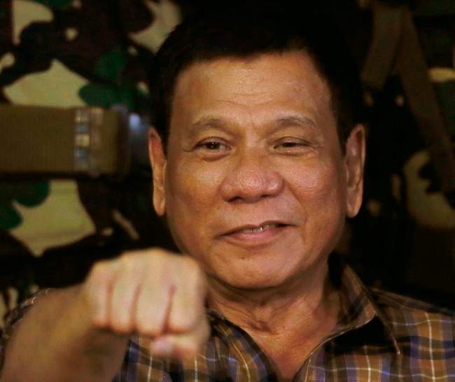 In this Aug. 25, 2016, file photo, Philippine President Rodrigo Duterte gestures with a fist bump during his visit to the Philippine Army's Camp Mateo Capinpin at Tanay township, Rizal province east of Manila, Philippines.