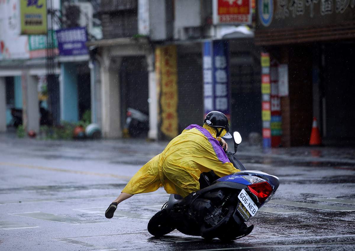A motorcyclist falls along a road as Typhoon Megi hits Hualien, eastern Taiwan, September 27, 2016.