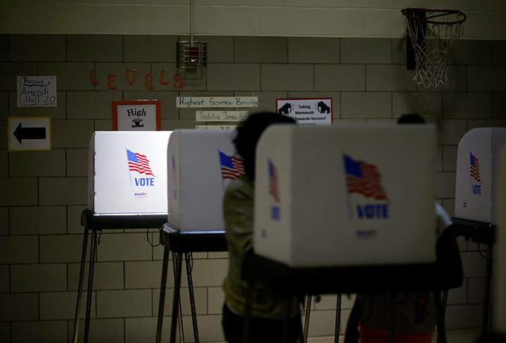 Sunlight shines through a window onto a voting booth at a polling place inside Winfield Elementary School in Windsor Mill, Md., Tuesday, April 26, 2016. 
