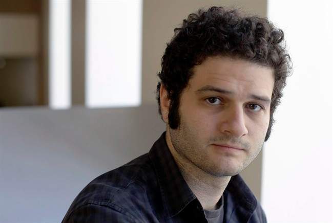 In this April 26, 2012 file photo, Dustin Moskovitz, a Facebook co-founder, poses outside of his office in San Francisco. Moskovitz says he is giving $20 million to help defeat Donald Trump, calling the Republican presidential candidate divisive and dangerous and his appeals to Americans who feel left behind "quite possibly a deliberate con.".