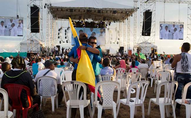 Observers embrace as Colombia-FARC peace accord is signed.