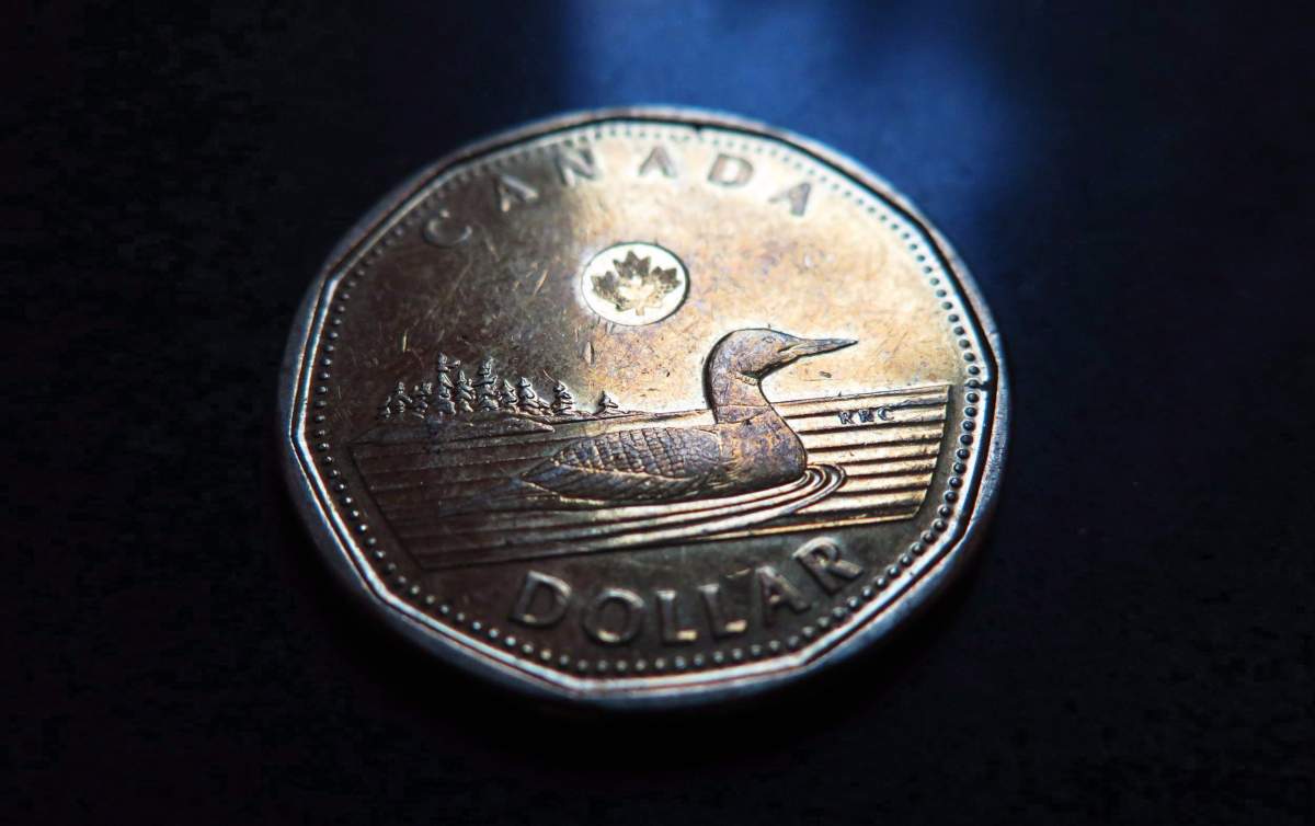 A Canadian dollar or loonie is pictured in North Vancouver, on March 5, 2014. A big bounce in energy prices and strength in metals sent the Canadian dollar soaring to its highest level since last summer.THE CANADIAN PRESS/Jonathan Hayward