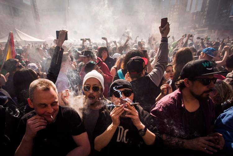 People smoke marijuana during a rally in Toronto,  April 20, 2016. 