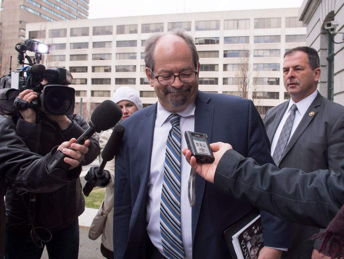 Quebec Native Affairs Minister Geoffrey Kelley grimaces as he reacts to Pierre Peladeau's resignation, at the Provincial Legislature in Quebec City on Wednesday, May 4, 2016. 