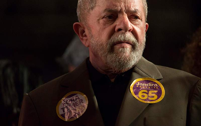 Brazil's former President Luiz Inacio Lula da Silva listens as Rio de Janeiro mayoral candidate Jandira Feghali speaks during a rally in Rio de Janeiro, Brazil. 