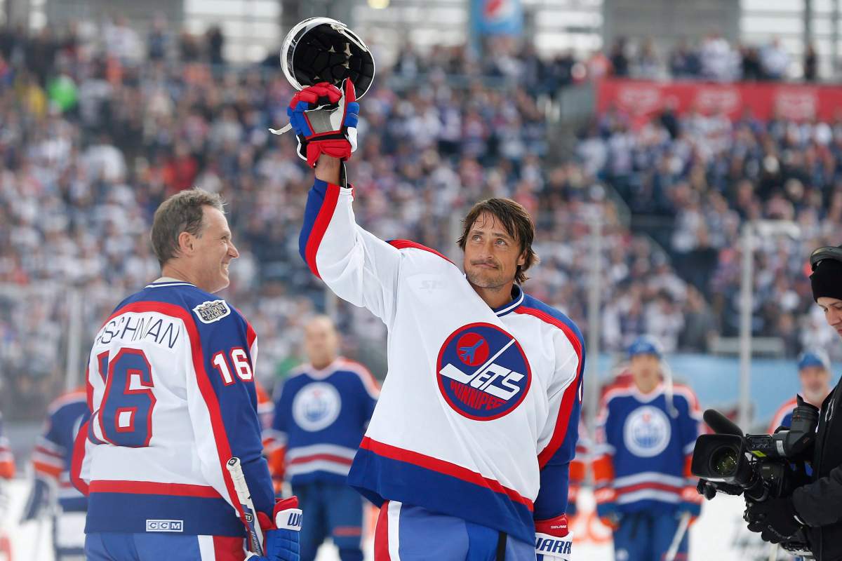 Former Winnipeg Jet Teemu Selanne (13) waves to the crowd at Investors Group Field prior to the first period of the NHL Heritage Classic Alumni game in Winnipeg on Saturday, October 22, 2016. 