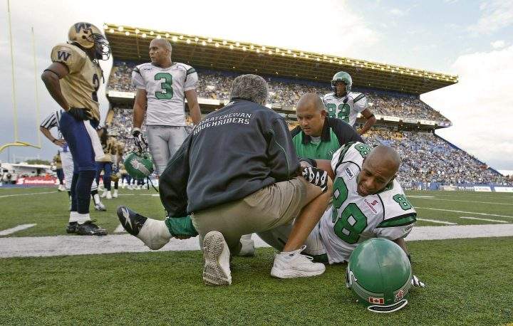 George Reed of the Saskatchewan Roughriders grimaces as he pulls tape from his ankle in the dressing room following the Grey Cup game in Ottawa in 1967.