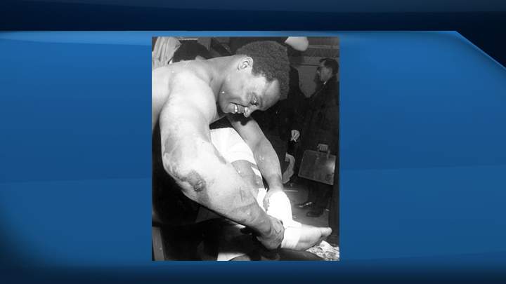 George Reed of the Saskatchewan Roughriders grimaces as he pulls tape from his ankle in the dressing room following the Grey Cup game in Ottawa in 1967.