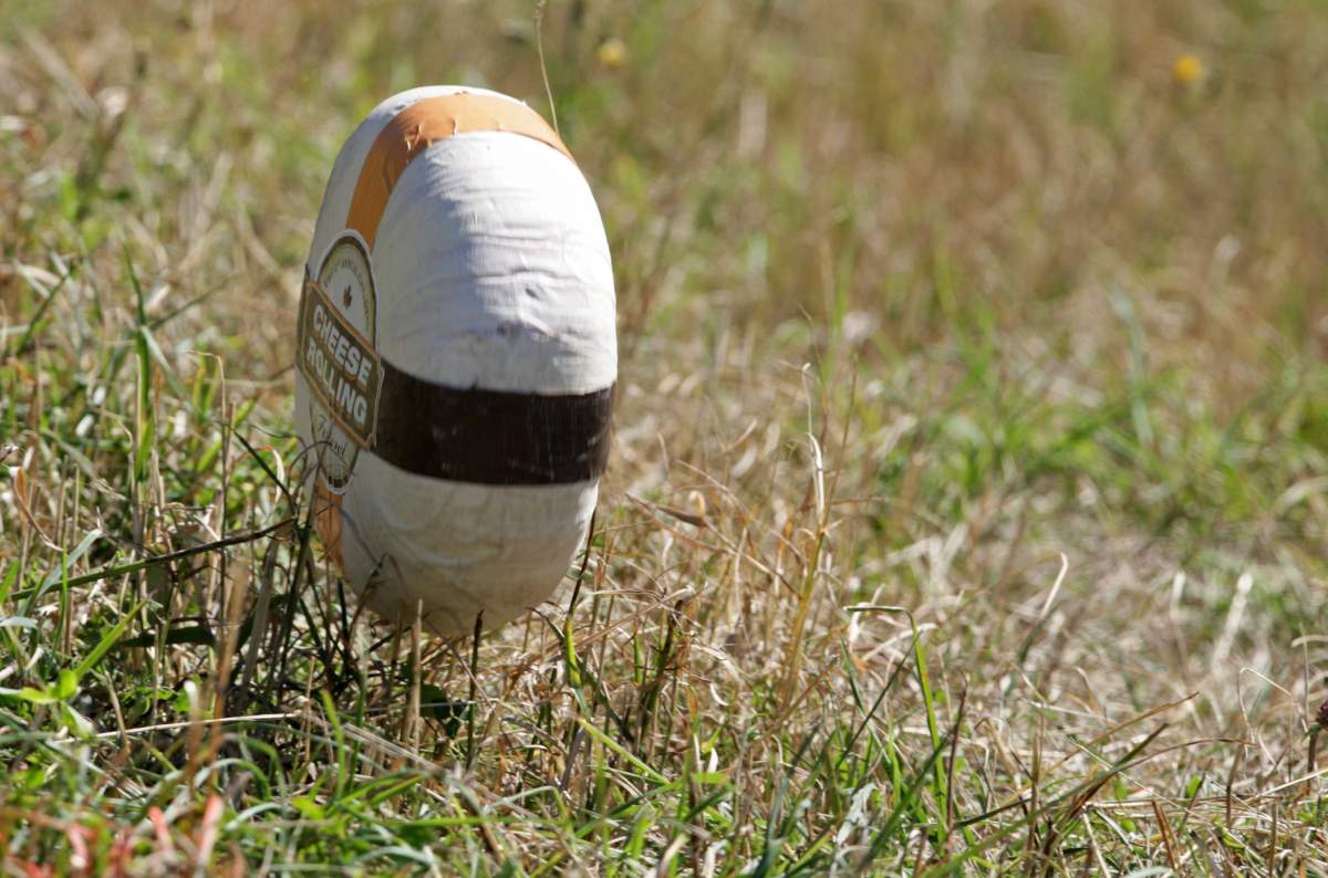 A wheel of cheese rolls down the hill during the first annual Canadian Cheese Rolling Festival in Whistler, B.C., on Saturday August 16, 2008. 